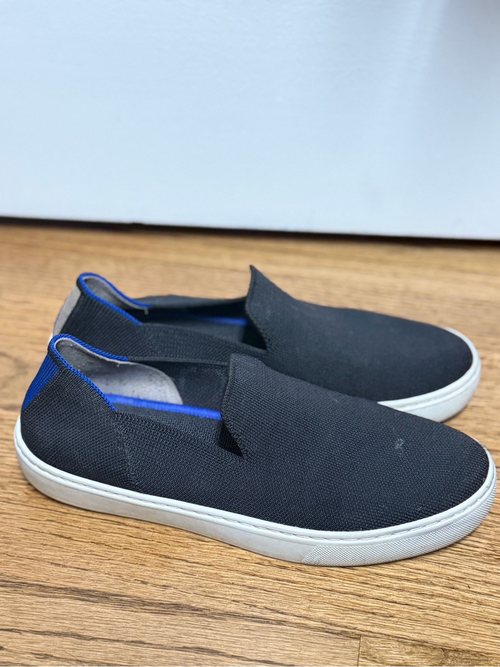 Rothy's Black Slip-On Flats with Blue Trim
